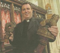 Revd Ian Finn at St Nicholas' church showing returned finials Finials